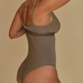 Aura olive green nursing bodysuit with crossed V-neck for breastfeeding, back view, made in Spain