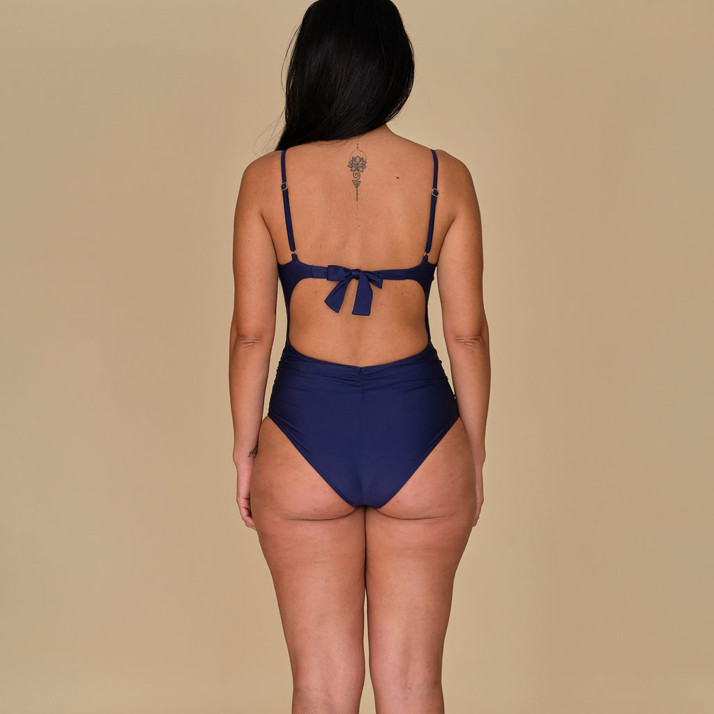 Woman in a swimsuit in navy blue made out of sustainable materials, made in Spain
