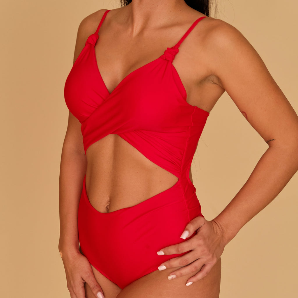 Woman in a maternity red swimsuit made with sustainable fabrics, made in Spain